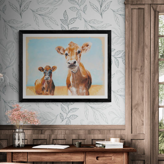 Jersey Cows art print in black frame displayed on flowery country wallpaper