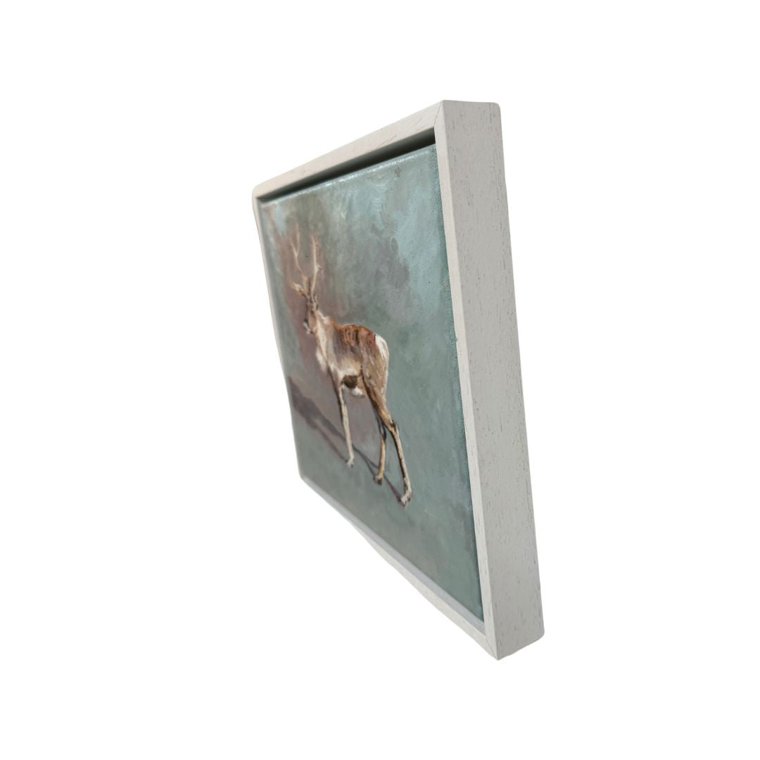 Rustic yet refined oil painting of a reindeer, showcased in a white wooden frame, a stunning addition to any seasonal or nature-themed decor.