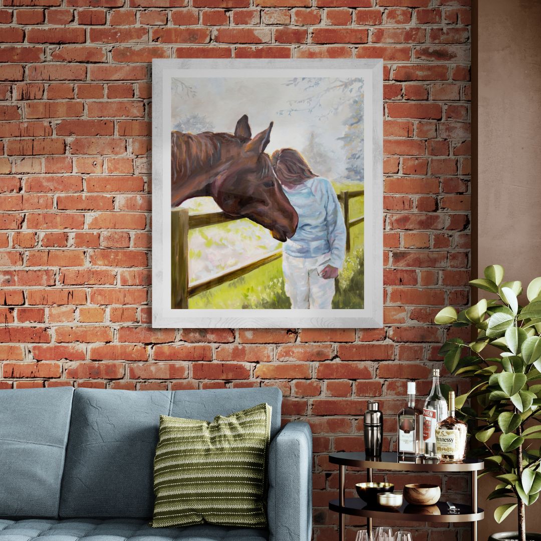 Horse and rider print in white frame on red brick wall